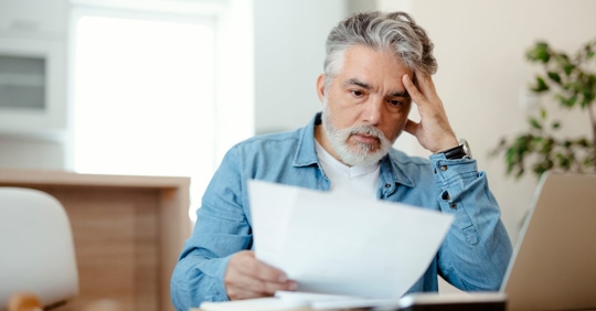 man looking at utility bill